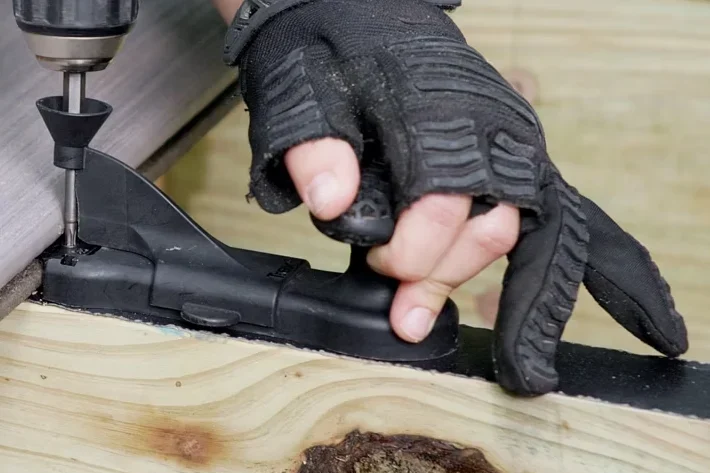 Installer fitting composite deck boards — tools and technique in action